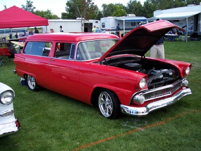 1972 Ford Ranchero - A red 1955 Ford station wagon is displayed with its hood open at an outdoor event.