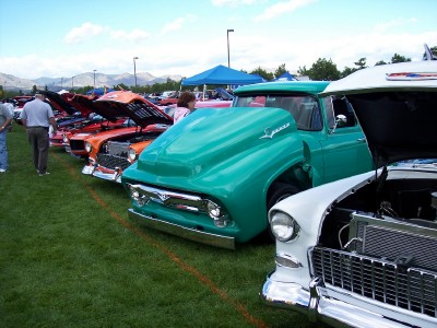1972 Ford Ranchero - Several classic vehicles are displayed on a grassy field under a bright sky.