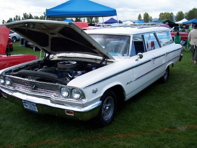 1972 Ford Ranchero - A white 1963 station wagon is displayed with its hood open, revealing the engine compartment.