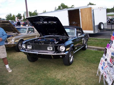 1972 Ford Ranchero - A black 1969 convertible is displayed with its hood open, alongside another vehicle and a trailer.
