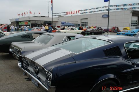 1978 Ford Mustang II - Several classic cars are parked outside a Ford dealership.