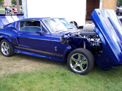 1972 Ford Ranchero - A blue 1967 Shelby GT500 is displayed with its hood open, the engine bay.