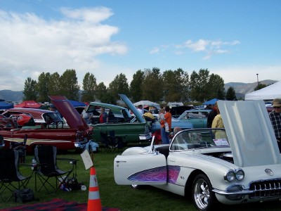 1972 Ford Ranchero - Several classic cars are displayed on a grassy field under a partly cloudy sky.