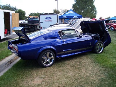 1972 Ford Ranchero - A blue 1968 Ford Mustang Shelby GT500 is displayed with its hood and trunk open at an outdoor event.
