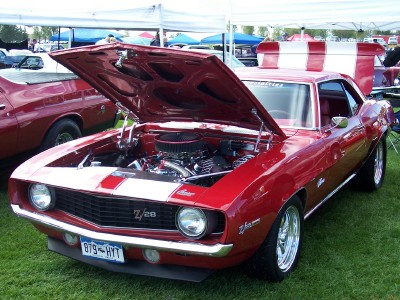 1972 Ford Ranchero - A red 1969 Chevrolet Camaro Z/28 is displayed with its hood open at an outdoor car show.