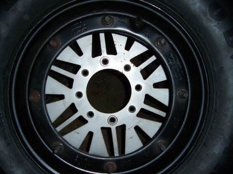 1983 Ford Bronco - This image shows a close-up view of a wheel, a beadlock and tire, with visible text on the wheel's rim.