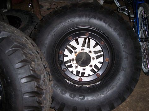 1983 Ford Bronco - Close-up of large off-road tires and a custom wheel, likely for an off-road vehicle.
