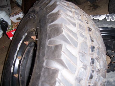 1983 Ford Bronco - A close-up view of a heavy-duty off-road tire and wheel assembly, likely for a truck or SUV.