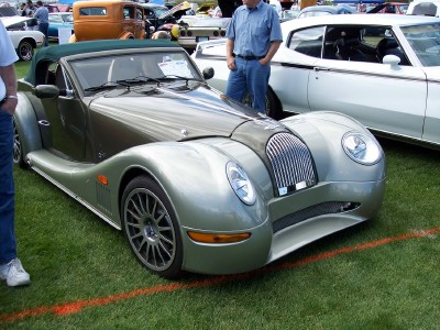 1972 Ford Ranchero - A Morgan Plus 8 convertible is displayed on a grassy field next to other vehicles.