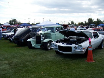 1972 Ford Ranchero - Outdoor car show features multiple vintage vehicles on display with hoods open.