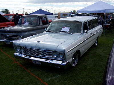 1972 Ford Ranchero - A light-colored 1964 Ford Falcon Squire station wagon is displayed at an outdoor car show.