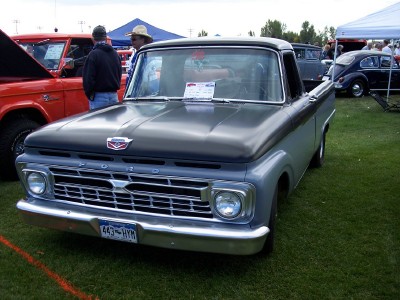 1972 Ford Ranchero - A classic Ford pickup truck is parked on a grassy field at an outdoor event.