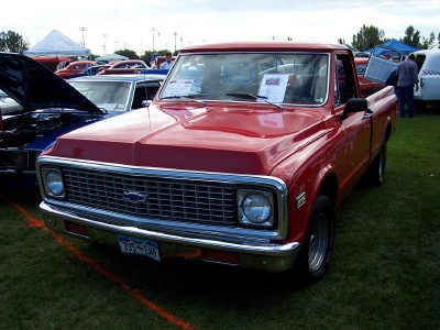 1972 Ford Ranchero - A red 1971 Chevrolet pickup truck is displayed at an outdoor car show.