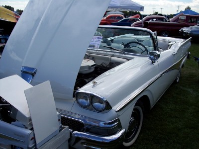 1972 Ford Ranchero - A white 1958 Ford Fairlane convertible is displayed with its hood open, revealing the engine and interior details.