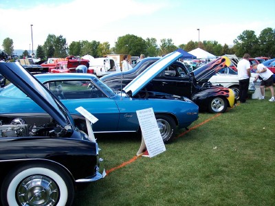 1972 Ford Ranchero - Outdoor car show with multiple classic vehicles on display, including a blue 1969 Camaro.