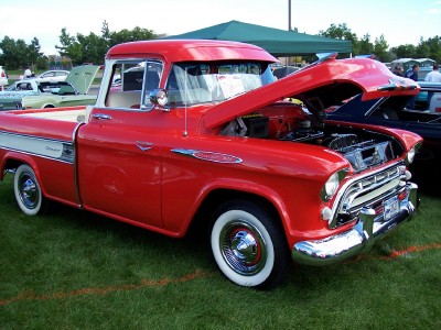 1972 Ford Ranchero - A classic red Chevrolet pickup truck is displayed with its hood open at an outdoor car show.