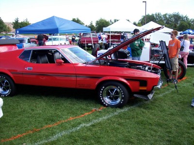1972 Ford Ranchero - A red 1971 Ford Mustang Mach 1 is displayed with its hood open at an outdoor car show.