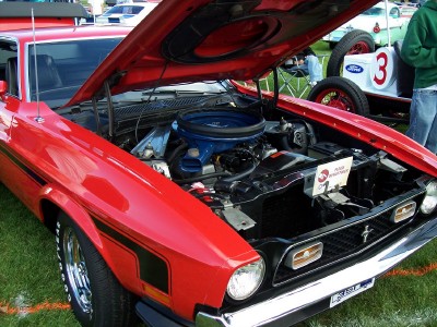 1972 Ford Ranchero - A red 1971 Ford Mustang is displayed with its hood open, showing the engine and other components.