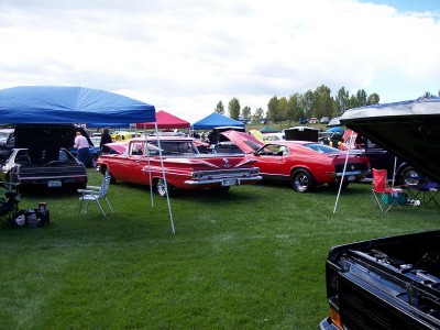1972 Ford Ranchero - Two classic vehicles displayed on a grassy field under tents at a car show event.