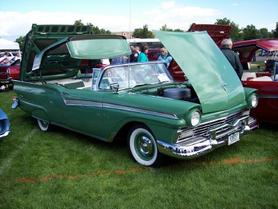 1972 Ford Ranchero - A green convertible with its roof and hood open is displayed at an outdoor car show.