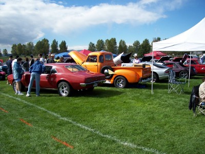 1972 Ford Ranchero - Several classic vehicles are displayed on a grassy field under a partly cloudy sky.