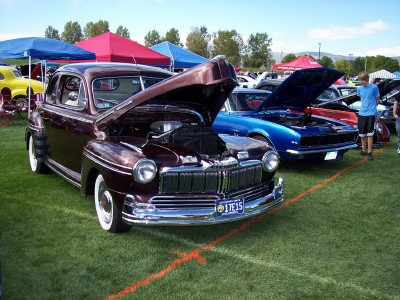 1972 Ford Ranchero - Classic Mercury coupe and other vehicles displayed at an outdoor car show event.