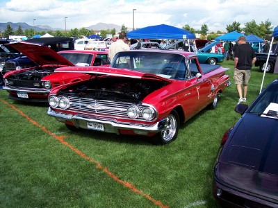 1972 Ford Ranchero - A red 1960 Chevrolet El Camino is displayed with its hood open at an outdoor car show.