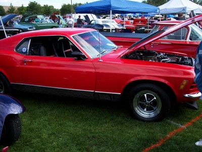 1972 Ford Ranchero - Red 1970 Ford Mustang Mach 1 at an outdoor car show with its hood open.