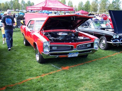 1972 Ford Ranchero - A red classic car is displayed with its hood open at an outdoor car show.