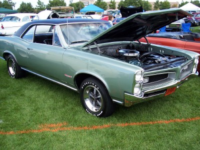 1972 Ford Ranchero - A green 1966 Pontiac GTO coupe is displayed with its hood open, revealing the engine compartment.