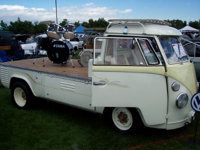 1972 Ford Ranchero - This Volkswagen Type 2 pickup truck, likely from the late 1960s, is equipped with a wooden flatbed and a drum kit.