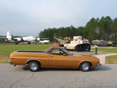 1966 Ford Ranchero - A 1972 Ford Ranchero is parked in front of military vehicles and aircraft at a museum.