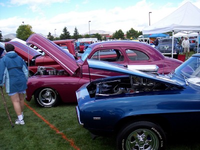 1972 Ford Ranchero - Multiple vehicles with their hoods open are displayed at an outdoor event under a cloudy sky.