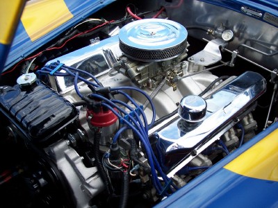 1972 Ford Ranchero - Close-up view of a modified engine bay, chrome components and blue wiring.