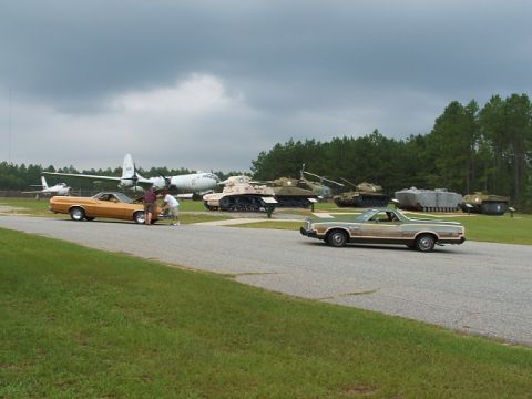 1966 Ford Ranchero - Two Ford Rancheros and military vehicles are on display at an outdoor museum.