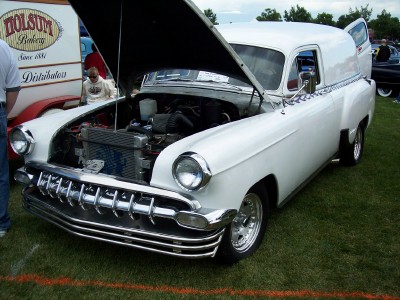 1972 Ford Ranchero - A white panel van, possibly from the 1950s, is displayed with its hood open at an outdoor event.