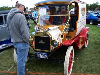 1972 Ford Ranchero - Antique Ford Model T truck with "The Butterfield" text on the side, viewed from the front at an outdoor car show.