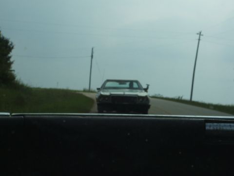 1966 Ford Ranchero - A car is seen from the perspective of another vehicle on a cloudy day.