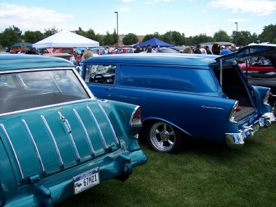 1972 Ford Ranchero - Two classic Chevrolet wagons are parked side-by-side on a grassy field at an outdoor event.