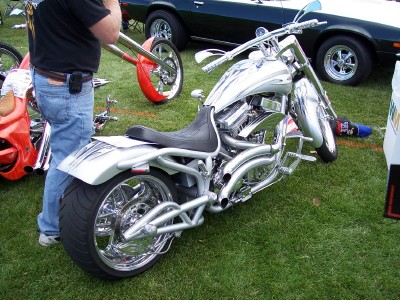 1972 Ford Ranchero - Custom motorcycle on display at an outdoor event, with other vehicles visible in the background.