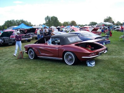 1972 Ford Ranchero - A classic red 1963 Chevrolet Corvette convertible is displayed at an outdoor car show event.