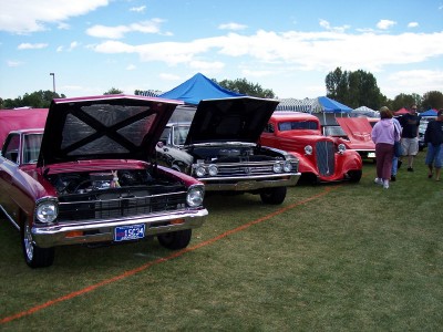 1972 Ford Ranchero - Several cars are displayed on a grassy field under a blue sky with tents in the background.