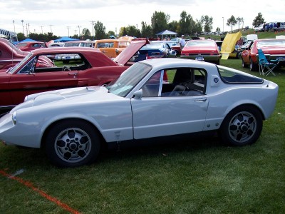 1972 Ford Ranchero - A light blue sports coupe is parked on grass at an outdoor car show.