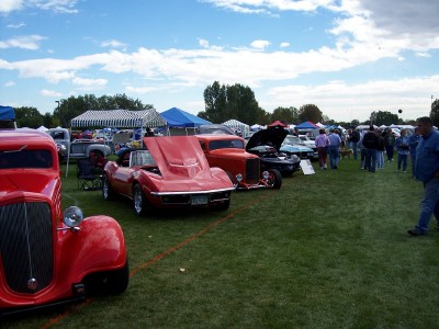 1972 Ford Ranchero - Several vehicles are on display at an outdoor car show under a partly cloudy sky.