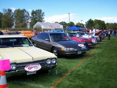 1972 Ford Ranchero - Multiple vehicles displayed on a grassy field during an outdoor car show event.
