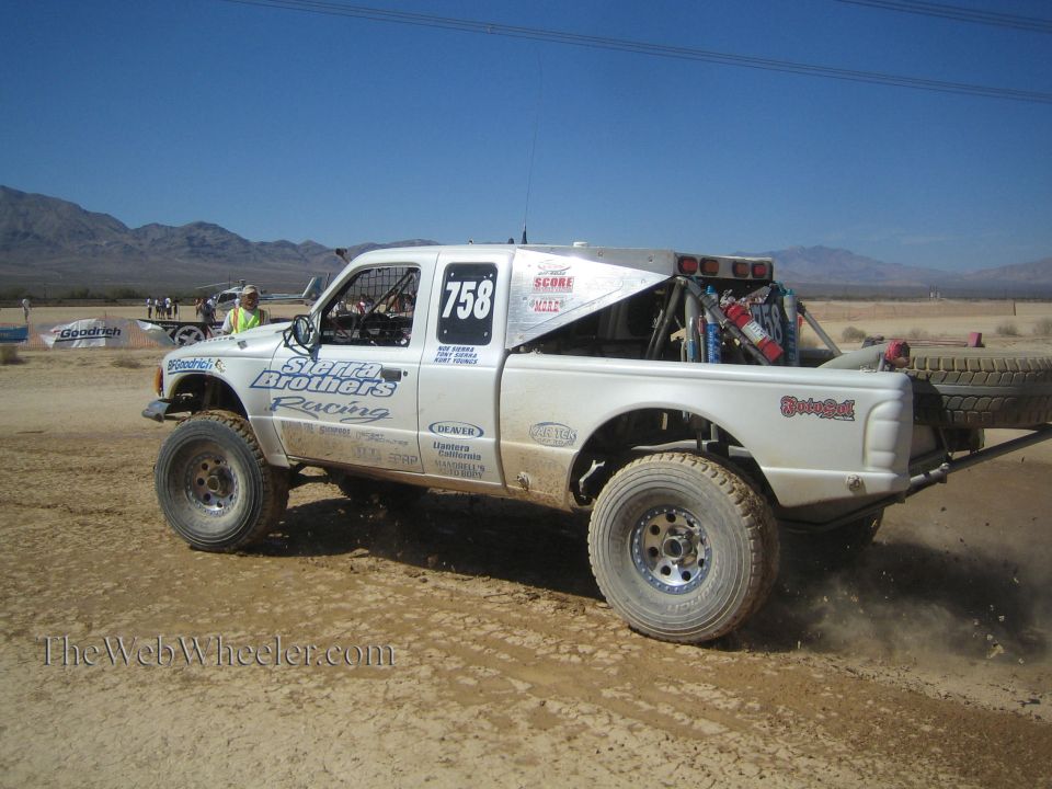White Sletten Brothers Racing #758 off-road truck driving across desert flat