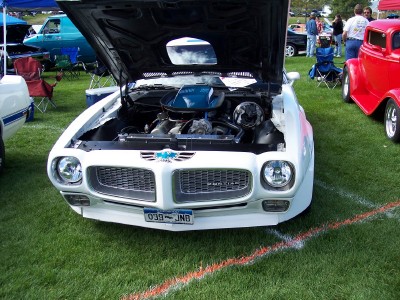 1972 Ford Ranchero - Front view of a 1970 Pontiac Firebird at an outdoor car show, hood raised to display the engine.