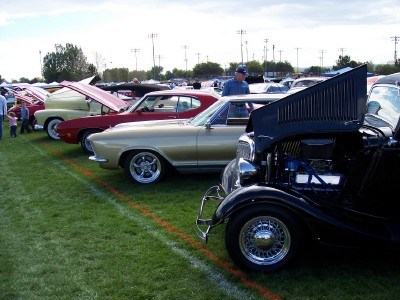 1972 Ford Ranchero - A lineup of vintage automobiles are displayed on a sunny day at an outdoor event.