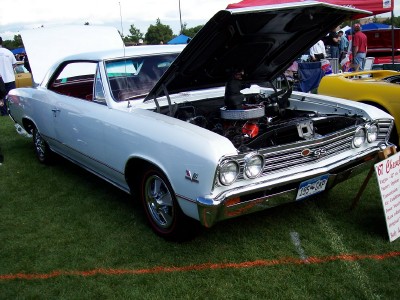 1972 Ford Ranchero - A light blue 1967 Chevrolet Chevelle SS is displayed with its hood open at an outdoor car show.