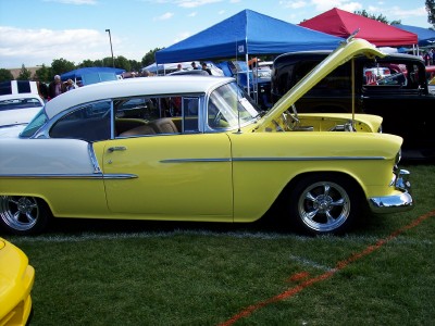 1972 Ford Ranchero - A yellow and white 1955 Chevrolet Bel Air coupe is displayed with its hood open at a car show.